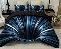 a bed covered in blue and black comforters