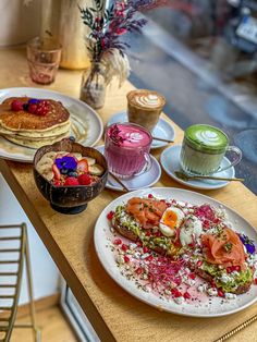 a table topped with plates of food and drinks