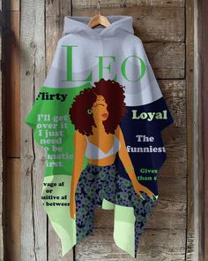 a woman's hoodie hanging on a wooden wall with the words leo written across it