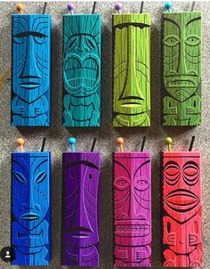 six colorful tiki lighters are lined up on the floor