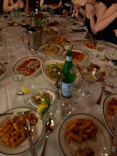 a group of people sitting around a dinner table