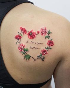 a woman's back with flowers and the words i love you mom written on it