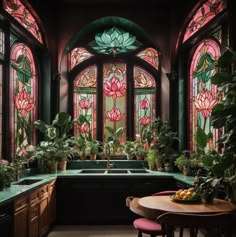 an ornate kitchen with stained glass windows and potted plants on the countertop, along with pink stools