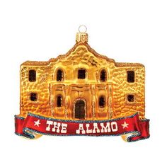 a gold ornament that says the alamo with an image of a building on it