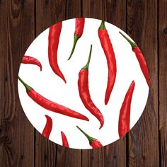 a white plate topped with red peppers on top of a wooden table