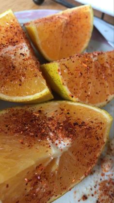 slices of oranges with seasoning on them sitting on a plate