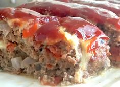 meatloaf covered in ketchup and onions on a plate