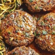 several hamburger patties with noodles and sauce