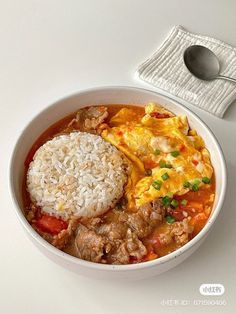 a white bowl filled with rice and meat