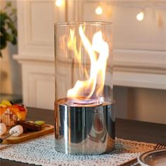 a candle that is on top of a table with some food in front of it