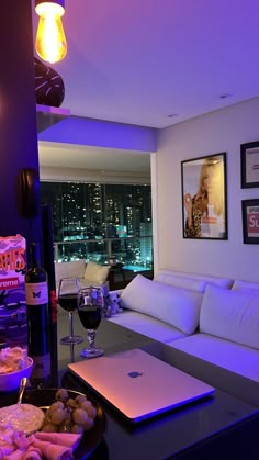 a living room filled with furniture and a laptop computer sitting on top of a table