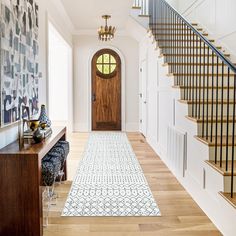 an entryway with stairs leading up to the second floor and another hallway on the other side