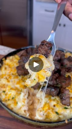 a person holding a spatula with meat and cheese on it in a skillet