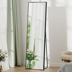 a large mirror sitting on top of a wooden floor