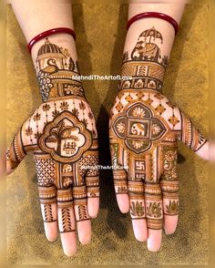 two hands with henna designs on them