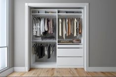 an open closet with clothes on hangers and drawers