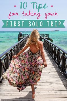 a woman walking across a bridge with the words 10 tips for taking your first solo trip