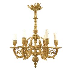 an antique chandelier with six candles on it