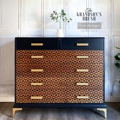 a black and gold chest of drawers in a room