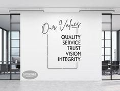 an office wall with the words quality, service, trust, vision and integity written on it