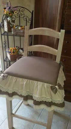 a wooden chair with a ruffled seat cover on it's back in a kitchen