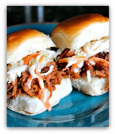 two pulled pork sandwiches on a blue plate