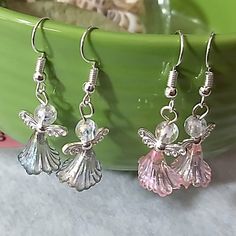 Beautiful Angel Dangle W Wings And Iridescent Beads Danity And Light Approx 1ninch Dabgle On Silver Tone Earrings Comes W Ear Backs And Tags Perfect For Gifting Holidays For Her Angels Babies Kids Purole Pink On Silver Tone Opal Like Rainbow Beads Very Cute Hand Assembled These My Self Sold As A Set Of 2 Come With Mesg Bag And Earring Back And Tags Ready For Gifting Coin Dime Is There To Compare Sizing So You Have An Idea On How Big It Is Handmade Winged Earrings For Gifts, Beaded Angel Ornaments, Pink Crystal Dangle Earrings With Ear Wire, Elegant Angel Wings Earrings For Gift, Handmade Spiritual Pink Earrings, Angel Bead Earrings Handmade, Diy Pumpkins Crafts, Beaded Angels, Angel Wing Earrings