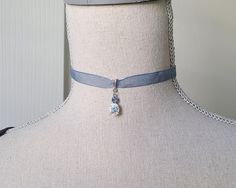 This lovely blue rose rhinestone choker is perfect for everyday wear as well as historical costumes. The ribbon just ties in the back so you can adjust the size. Reminiscent of the Regency style and inspired by the Bridgerton series. Bail and charm setting are nickel free. Comes in a lovely gift box with ribbon. In the Eighteenth and Nineteenth centuries, chokers were very fashionable. Some were made of pearls, lace or ribbon and can be seen in many classic portraits. I think they're a very eleg Ribbon Choker Aesthetic, Regency Jewelry, Bridgerton Series, Bridgerton Inspired, Ribbon Choker, Classic Portraits, Rhinestone Choker, Historical Costume, Jewelry Choker