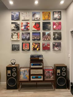 a room with speakers and pictures on the wall