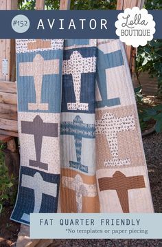 a quilted blanket sitting on top of a wooden bench