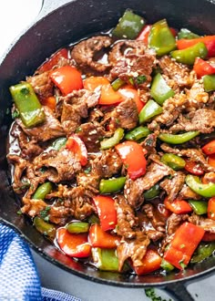 a skillet filled with beef and peppers