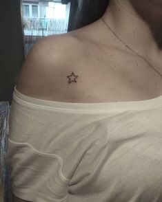 a woman with a small star tattoo on her chest