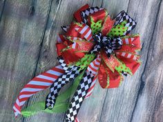 a red and green bow on top of a wooden table