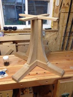 a wooden work bench being built in a workshop with tools on the table and behind it is a window