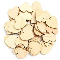 wooden hearts are arranged on a white surface