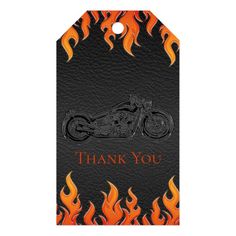 a black and orange motorcycle with flames on it's back is the words, thank you