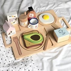 a wooden tray with breakfast foods on it