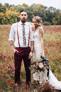 a bride and groom standing in the middle of a field