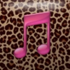 a pink musical note sitting on top of a leopard print wall