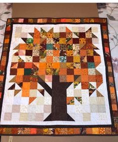 a quilted tree with leaves on it and the words, how to make a patchwork tree