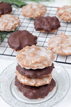 chocolate covered cookies sitting on top of a glass plate