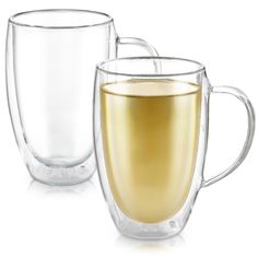 two glass mugs filled with liquid sitting next to each other