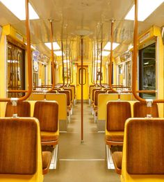 the inside of a train with yellow seats