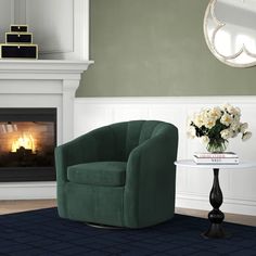 a living room with a green chair and fireplace