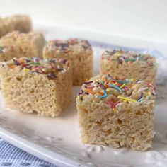 several pieces of cake on a plate with sprinkles