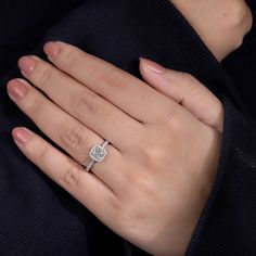 a woman's hand with a diamond ring on it