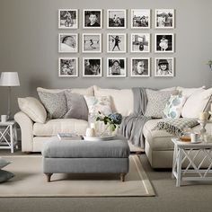 a living room filled with lots of furniture and pictures on the wall above it's coffee table