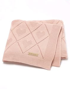 a pink knitted blanket folded on top of each other