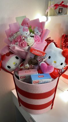 a hello kitty gift basket with pink roses and teddy bears in the corner next to it