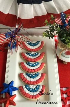 patriotic cookies decorated with red, white and blue icing are on a platter